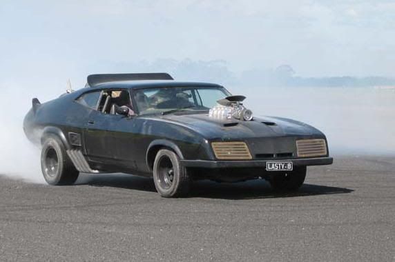 Leaps into the last of the V8 Interceptors and roars off through the piles